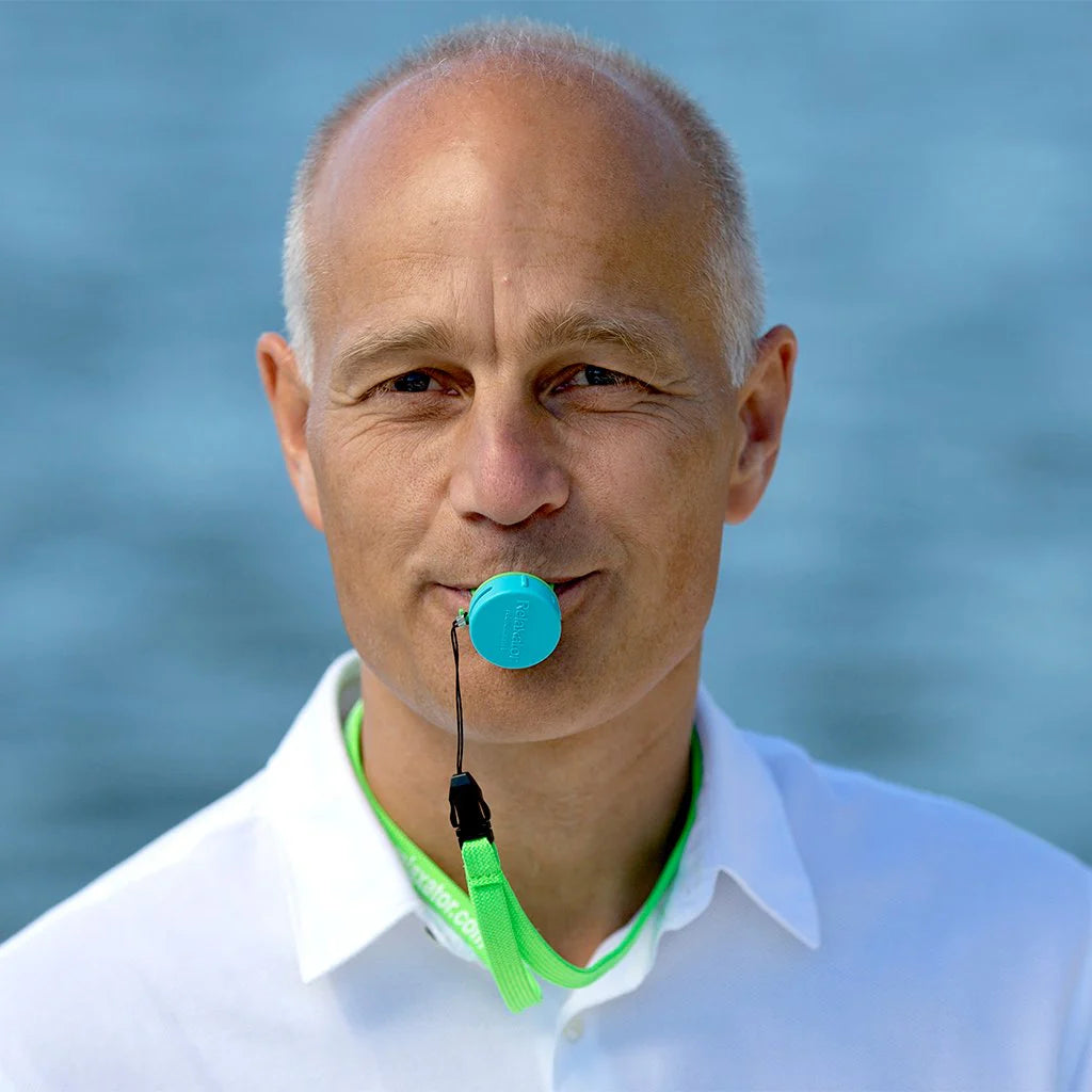 Image of a man with the Relaxator breath trainer in his mouth.