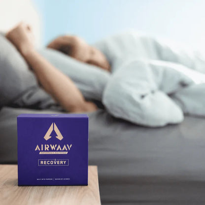 image of a person asleep with the airwaav recovery on their night stand.